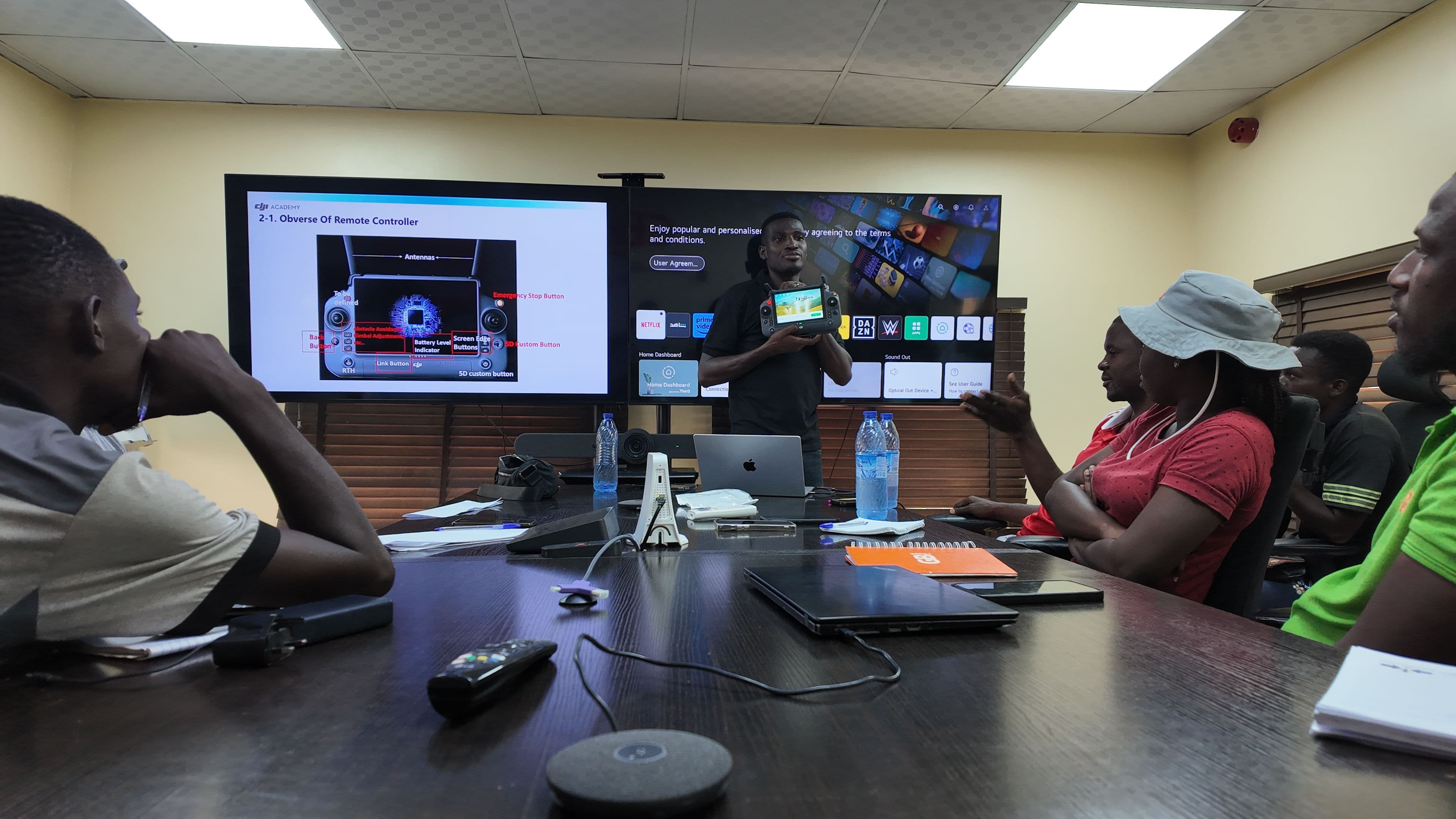 Femi Adekoya showing a drone remote controller that is infused with AI