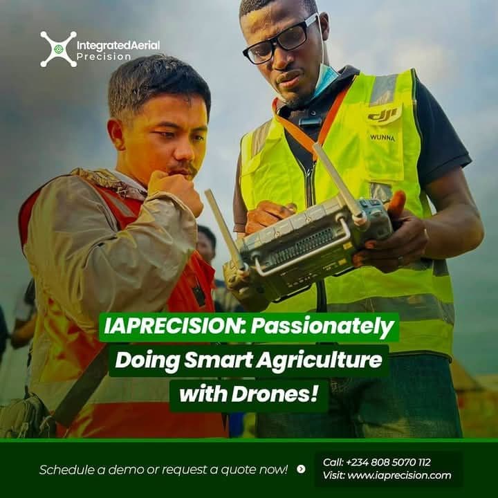 Femi Adekoya and a representative from DJI looking at a drone controller