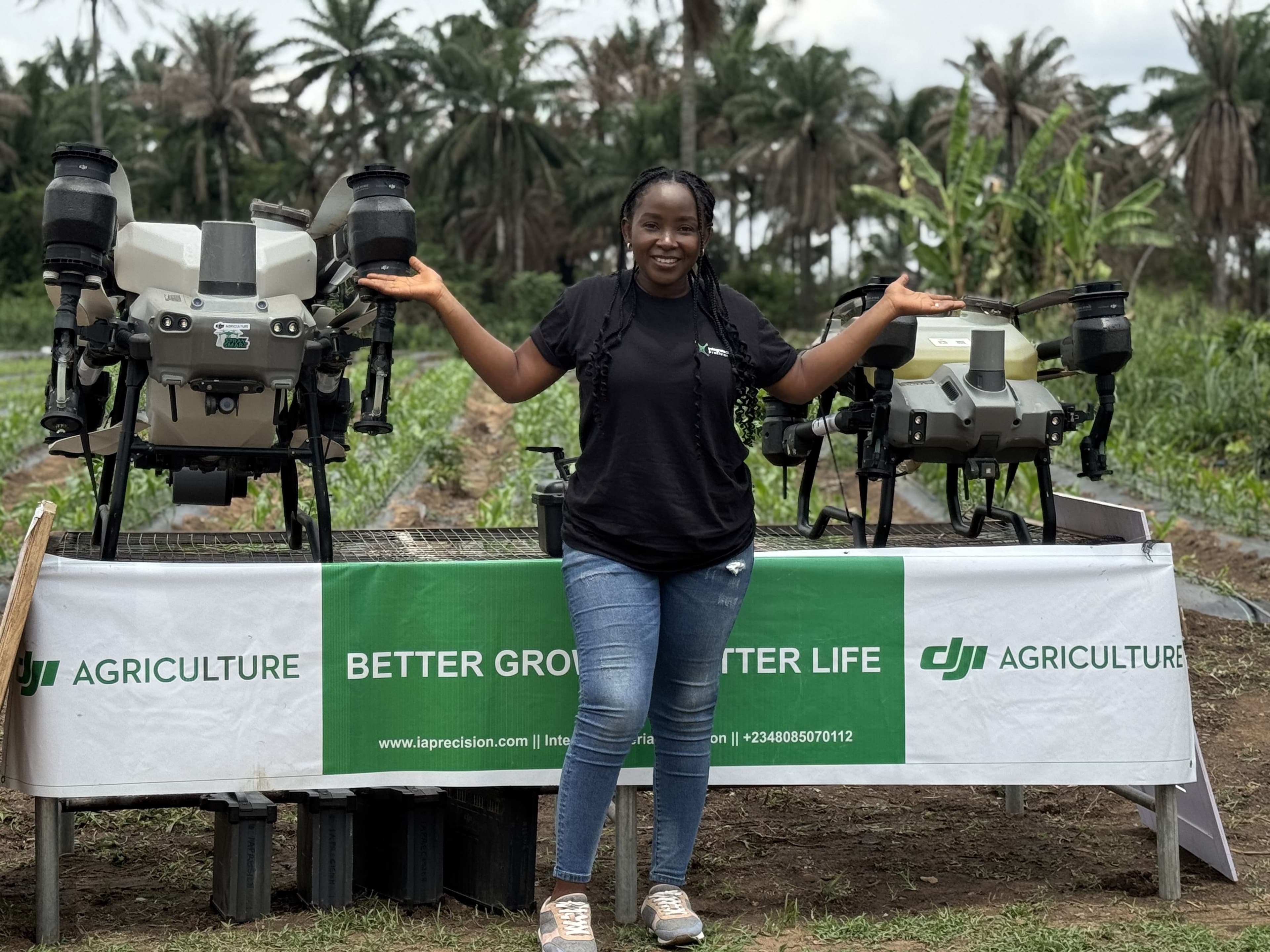 A team member at Iaprecision standing in front of AGras T50 and T25 drones